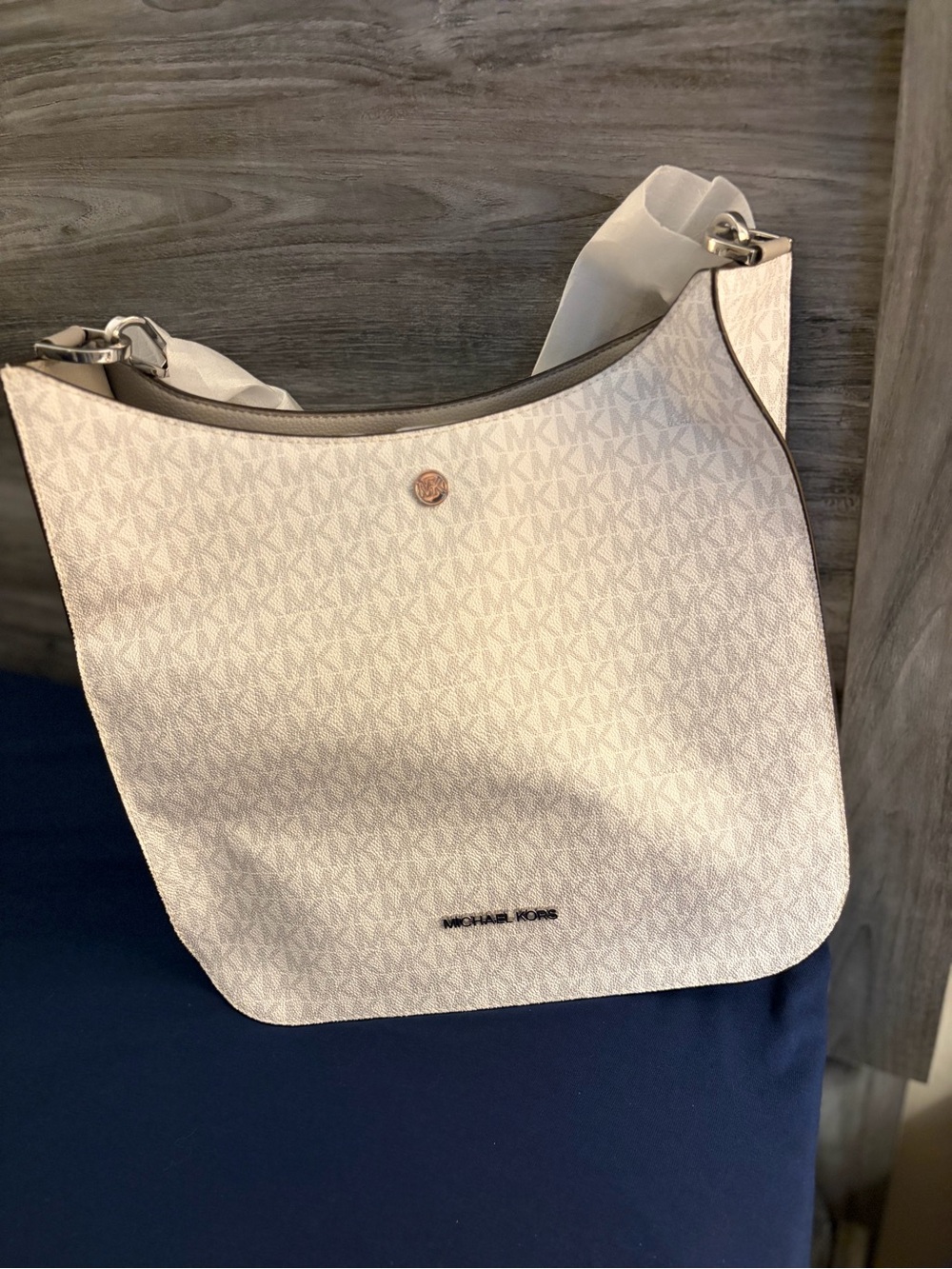 The Michael Kors Briley Large Messenger Crossbody in vanilla monogram canvas